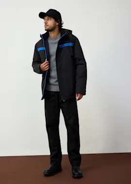 Sportliche Winterjacke mit blauen Akzenten, grauer Pullover und schwarze Hose.