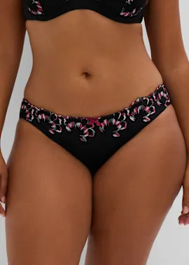 Das elegante schwarze Dessous-Set besticht mit bunter, floraler Stickerei und Rüschen.