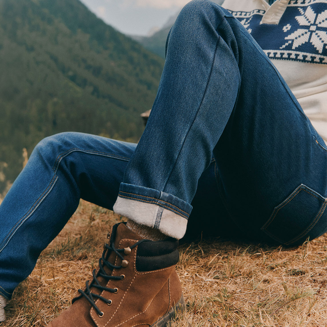 Robuste Jeans, warme Stiefel und ein gemütlicher Norwegerpullover für die Berge.