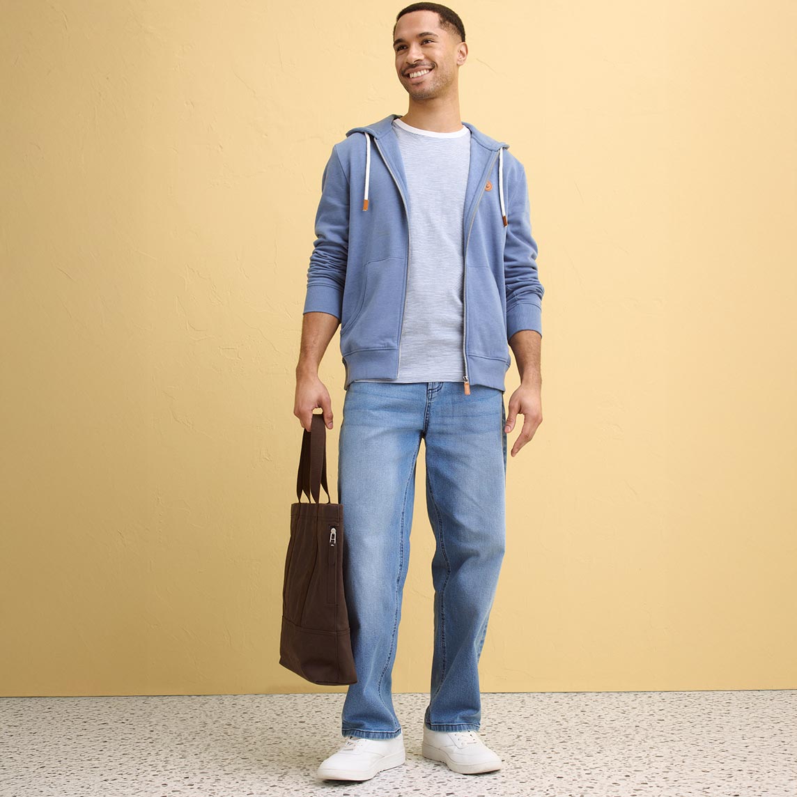 Hellblaue Kapuzenjacke über weißem T-Shirt, kombiniert mit Jeans.