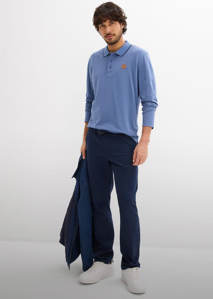 Hellblaues Langarm-Poloshirt kombiniert mit lockerer blauer Hose.