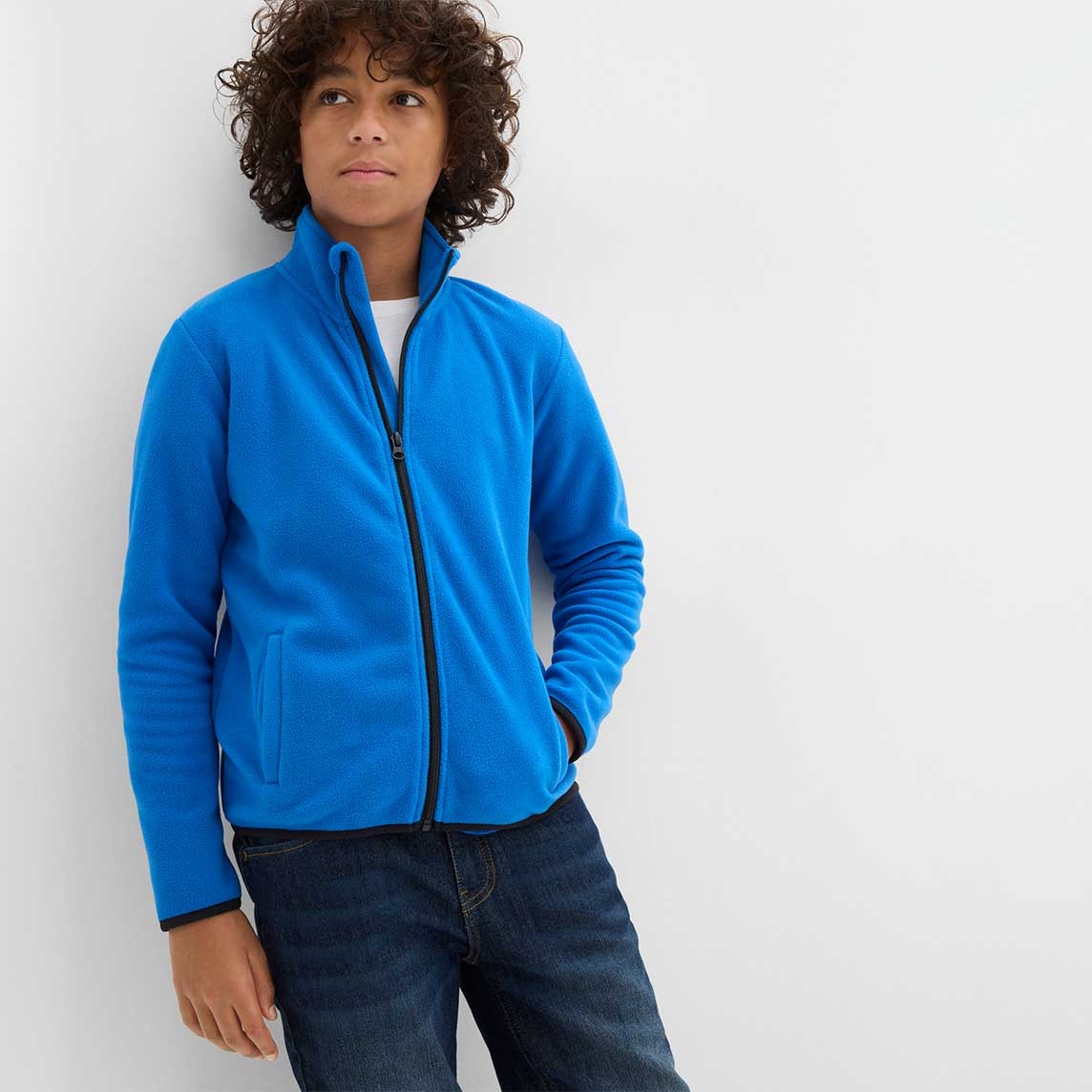 Junge trägt blaue Fleecejacke.