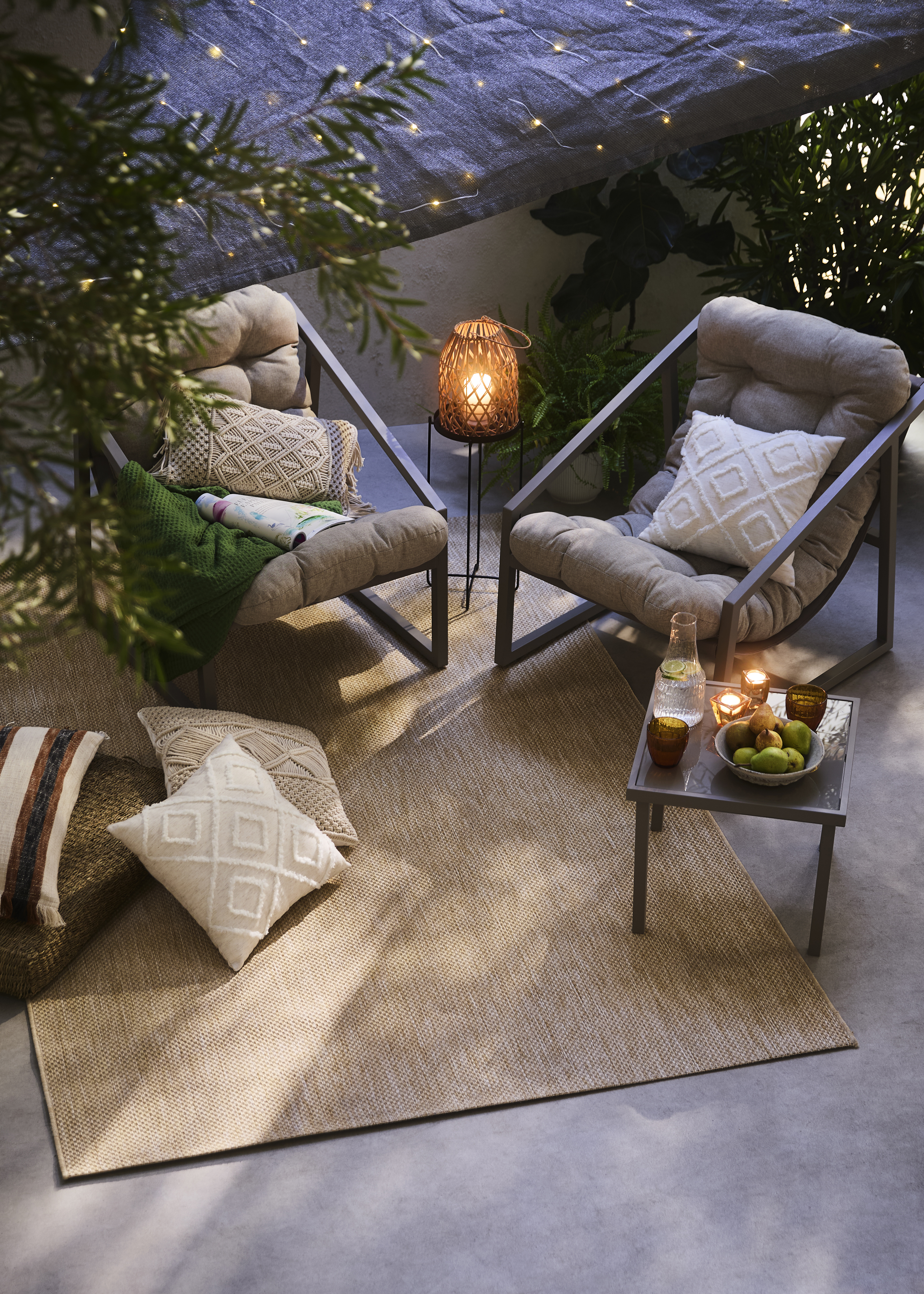 Gemütliche Terrassenoase mit weichen Kissen, warmen Decken und eleganten Stühlen für entspannte Abende.