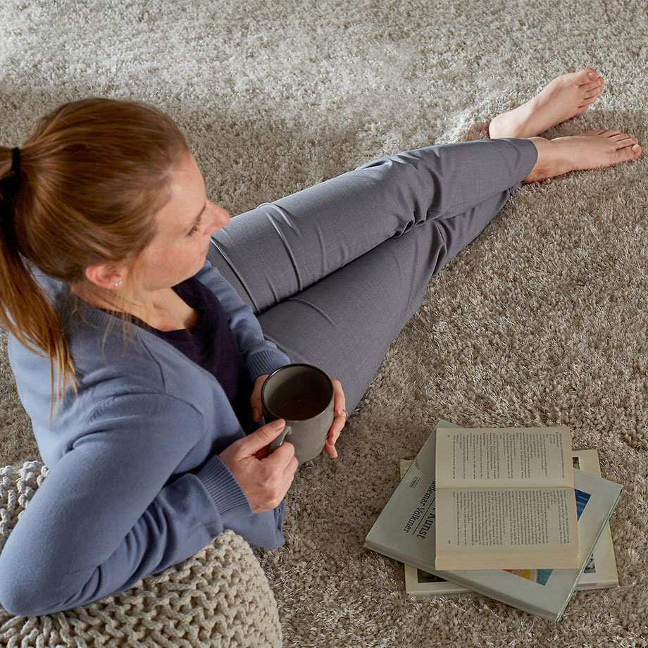 Gemütlicher Lesemoment in grauem Outfit: Bequeme Leggings und Pullover für entspannte Stunden zuhause.
