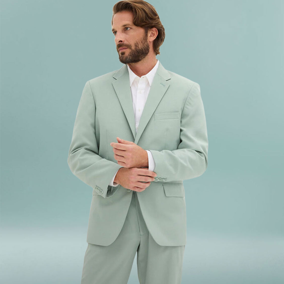 Eleganter Mann trägt hellgrünen Anzug mit weißem Hemd in klassischem Stil.