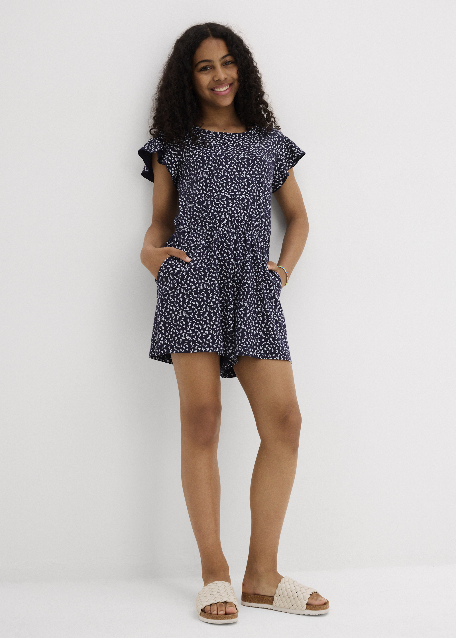 Lässiger schwarzer Jumpsuit mit weißem Punktmuster.