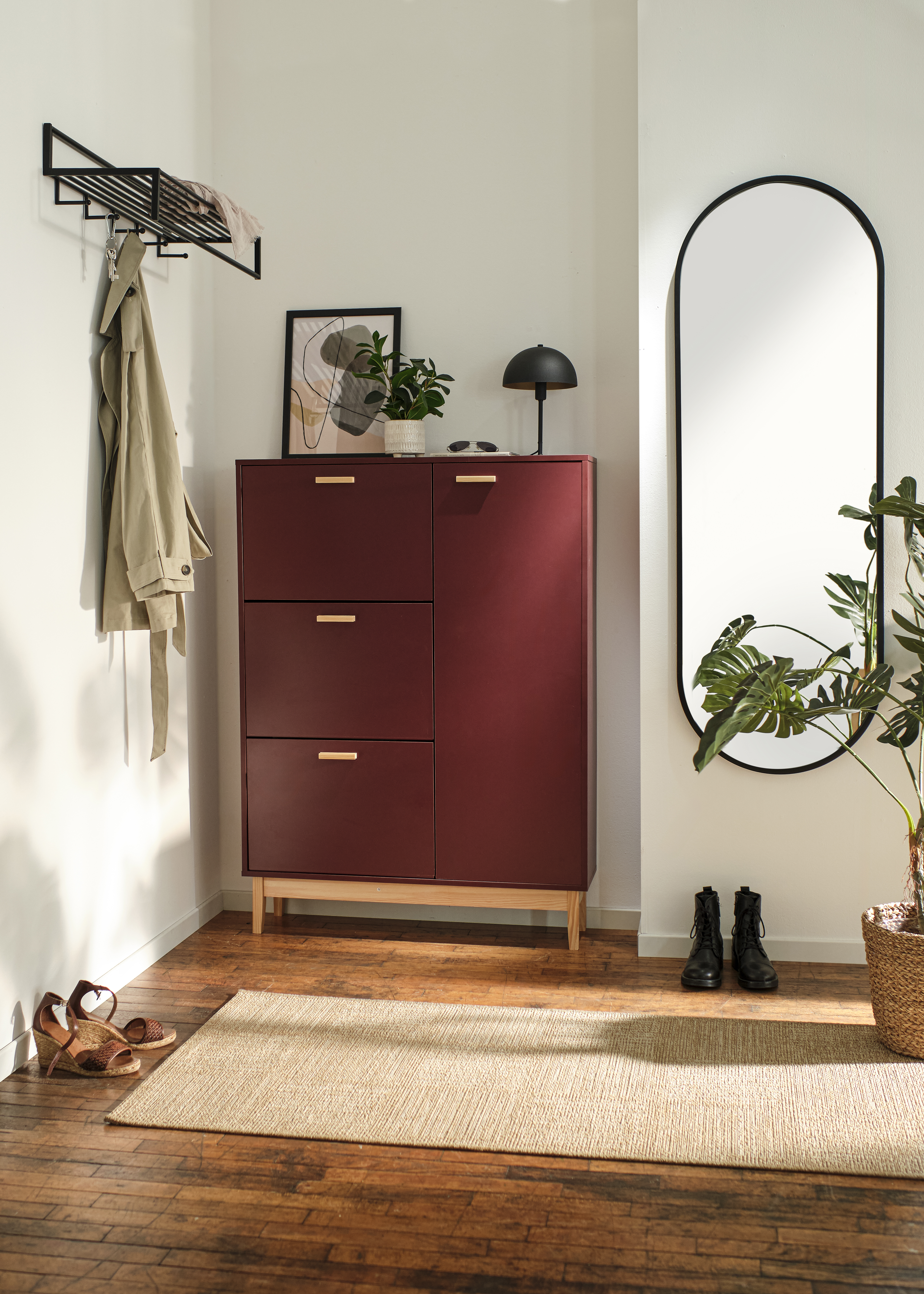 Moderner Flur mit roter Kommode und Spiegel an der Wand.