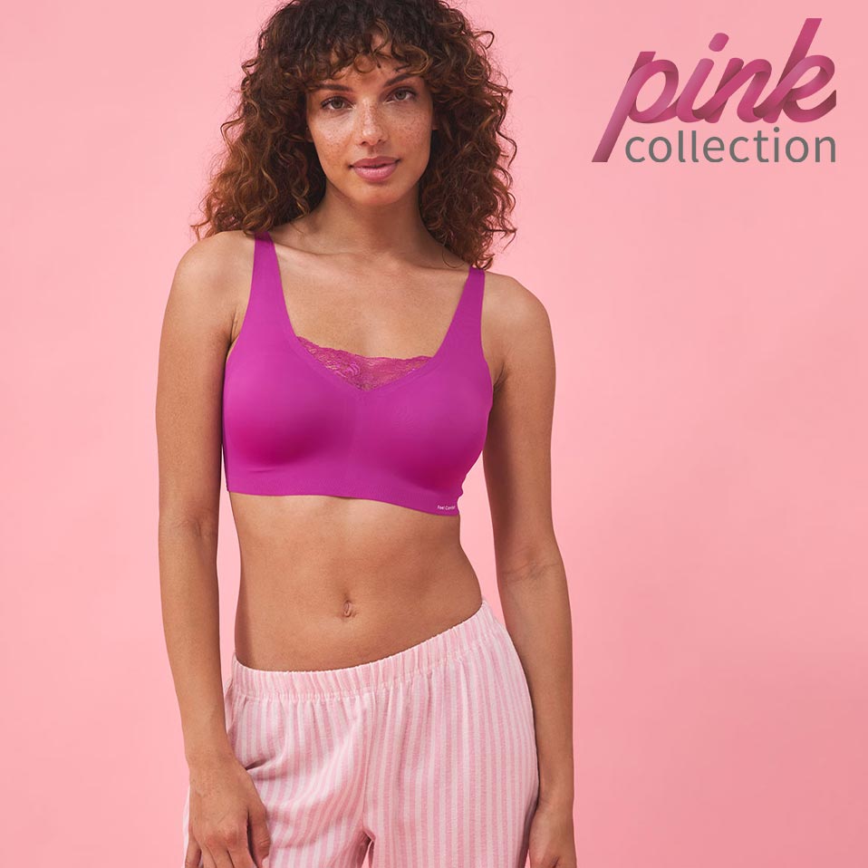 Sportliches Outfit: Lila Crop-Top und gestreifte rosa Hose. Perfekt für Fitness und Freizeit.