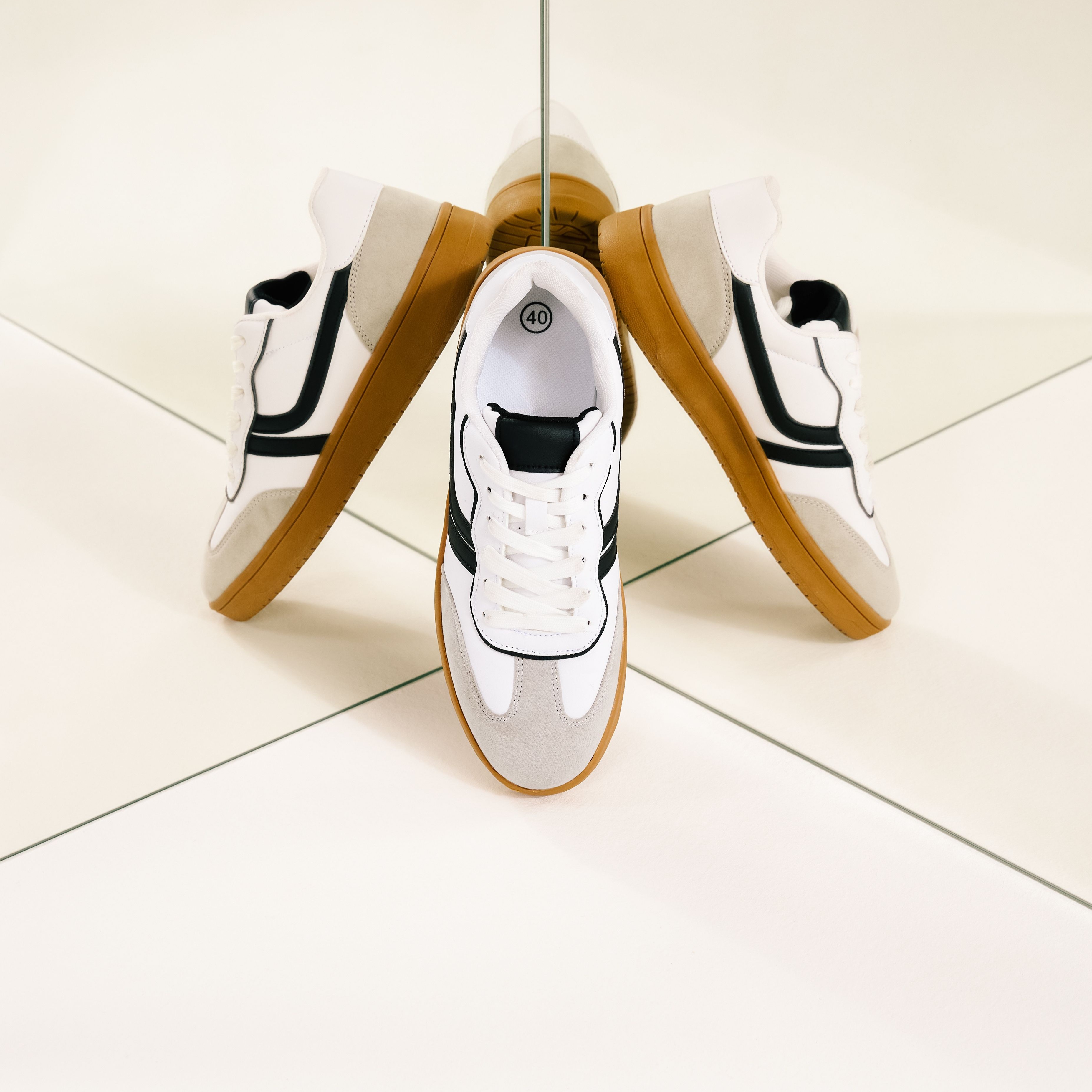 Sportliche weiße Sneaker mit gelben Akzenten und Gummisohle, perfekt für lässige Outfits.