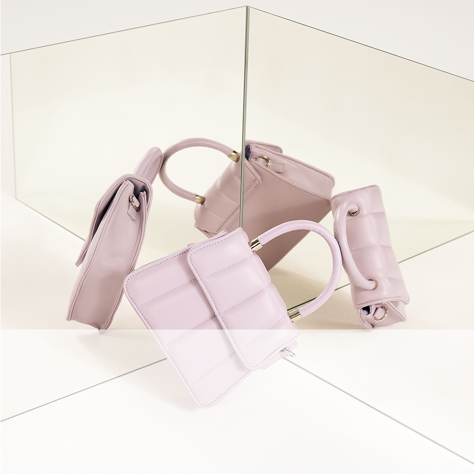 Pastellfarbene Handtaschen in verschiedenen Formen und Größen, elegant und stilvoll arrangiert.