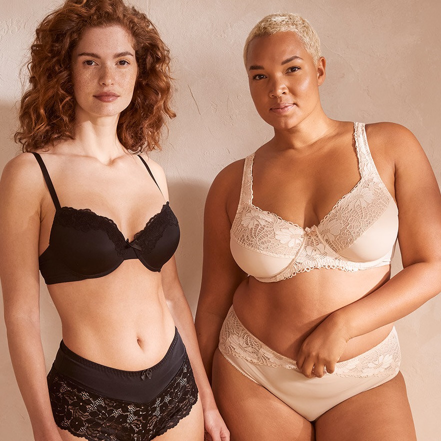 Elegante Dessous in Schwarz und Creme: BHs und Höschen für verschiedene Figurtypen.