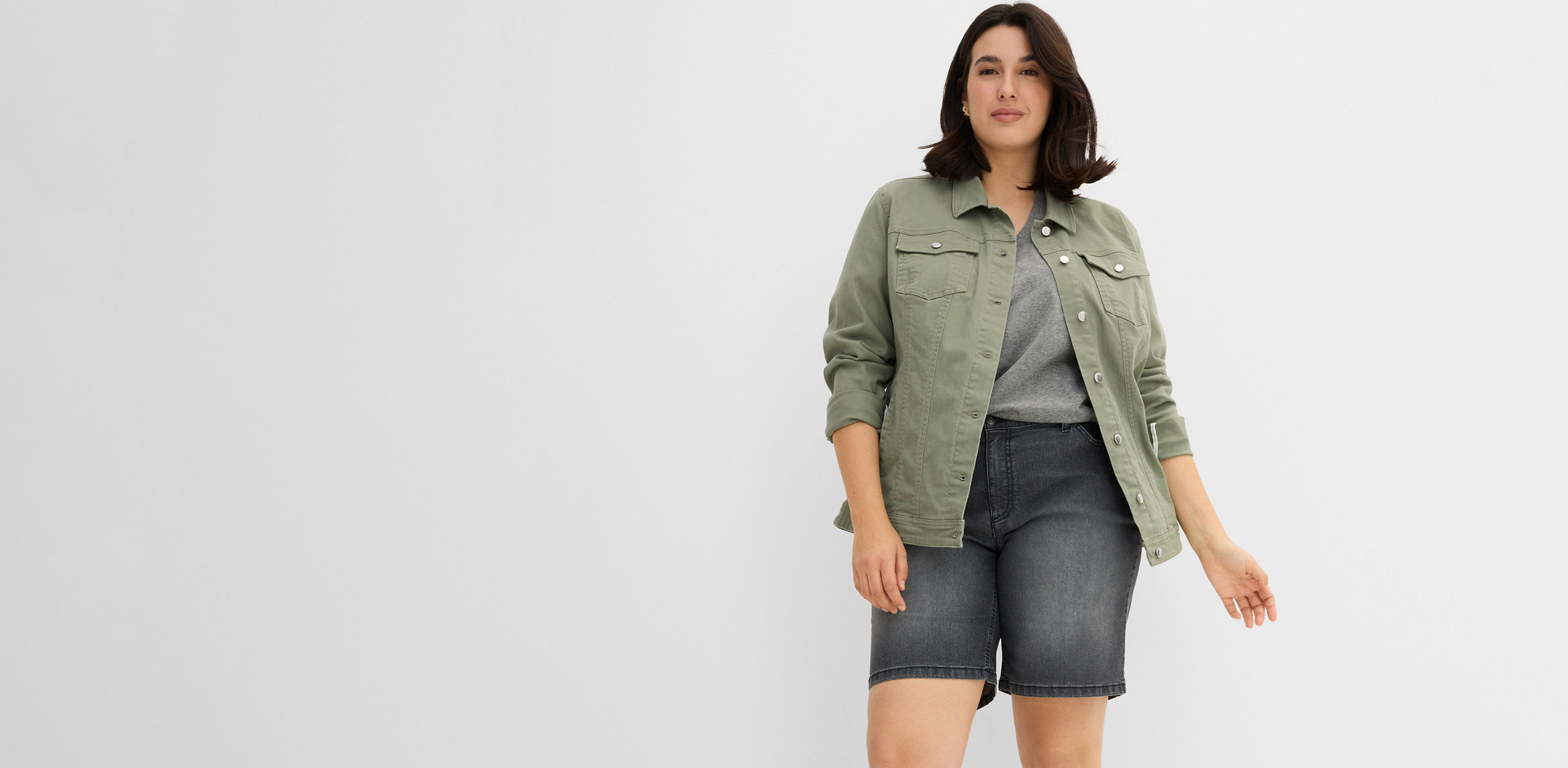 Kombination aus grüner Jacke, grauem Top und passender Shorts.